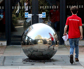 Student Ambassador walking wearing a Liverpool Hope t-shirt